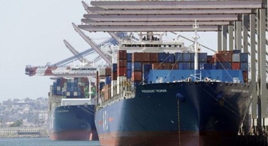 Cargo ships loading at a port